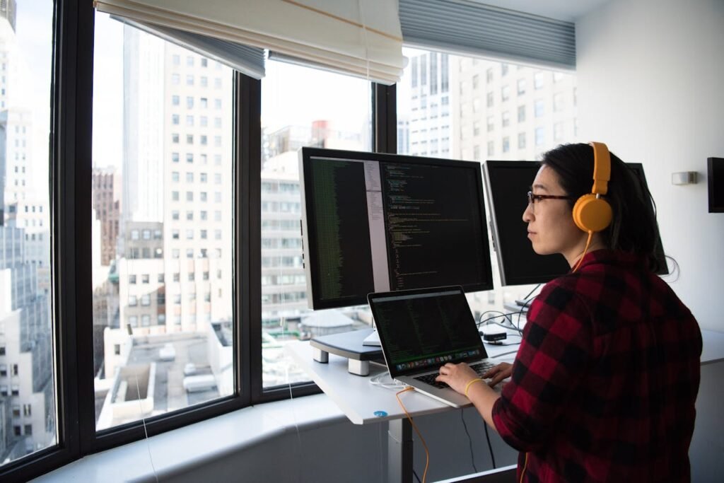 Woman Sitting While Operating Macbook Pro